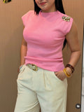 Blusa broche de flor